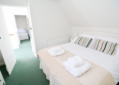 King bed in bedroom of 3 bed self catering accommodation near winchester