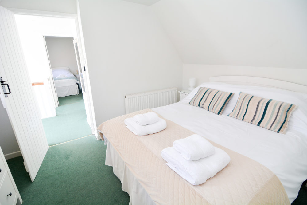 King bed in bedroom of 3 bed self catering accommodation near winchester